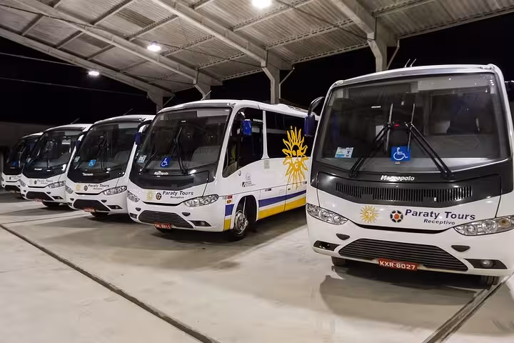 Paraty Tours shuttle buses parked at a terminal, showcasing reliable transport for Ilha Grande to Paraty shared transfers.