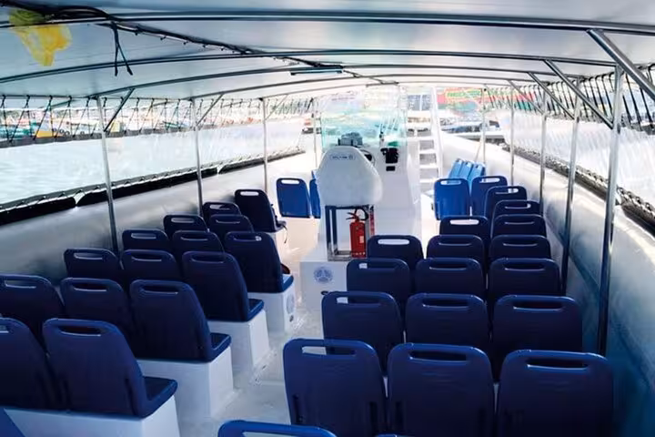Interior of a spacious ferry offering transport between Ilha Grande and Rio de Janeiro with multiple seating arrangements.