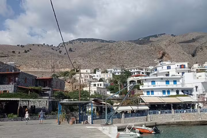 Scenic coastal village near Imbros Gorge, showcasing stunning mountain backdrop and traditional architecture.