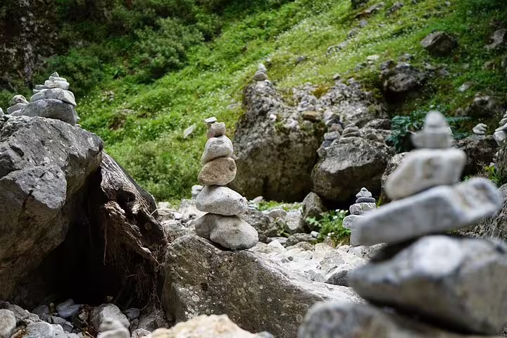 Stacked stones and lush greenery along the Imbros Gorge hiking trail, ideal for a private nature adventure tour.