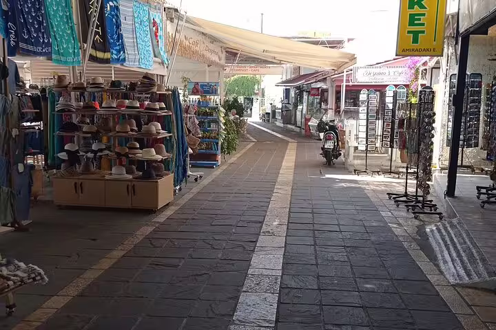 Charming narrow street in Imbros with colorful market stalls, perfect for exploring during the Imbros Gorge Adventure Hike.