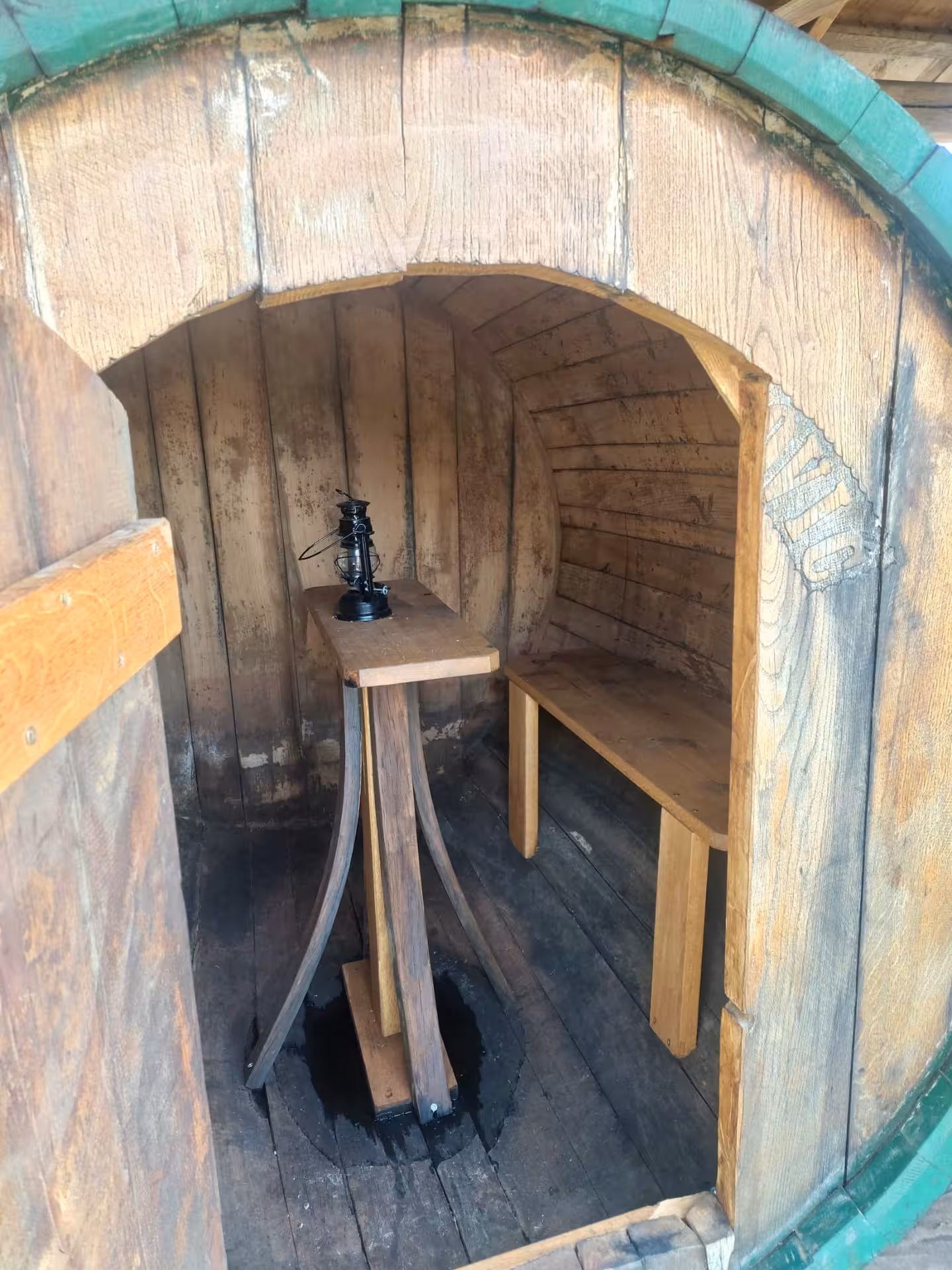 Inside a wooden wine barrel tasting nook at Imotski winery, authentic Split hidden gems wine tour experience