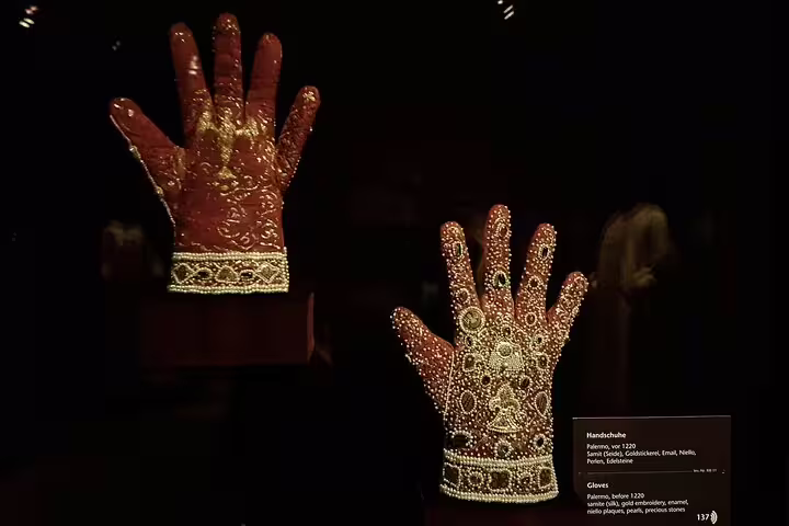 Ornate jeweled gloves from the Imperial Treasury, showcasing intricate medieval craftsmanship and precious stones.
