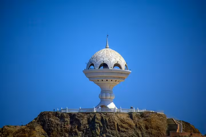Iconic incense burner monument on a rocky hill under clear blue sky, a must-see stop on private Muscat city sightseeing tours