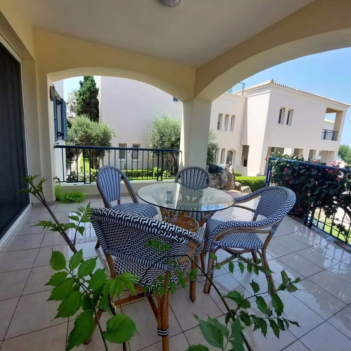 Charming villa balcony with elegant seating, offering scenic views and lush greenery at Infinity Night Villa.