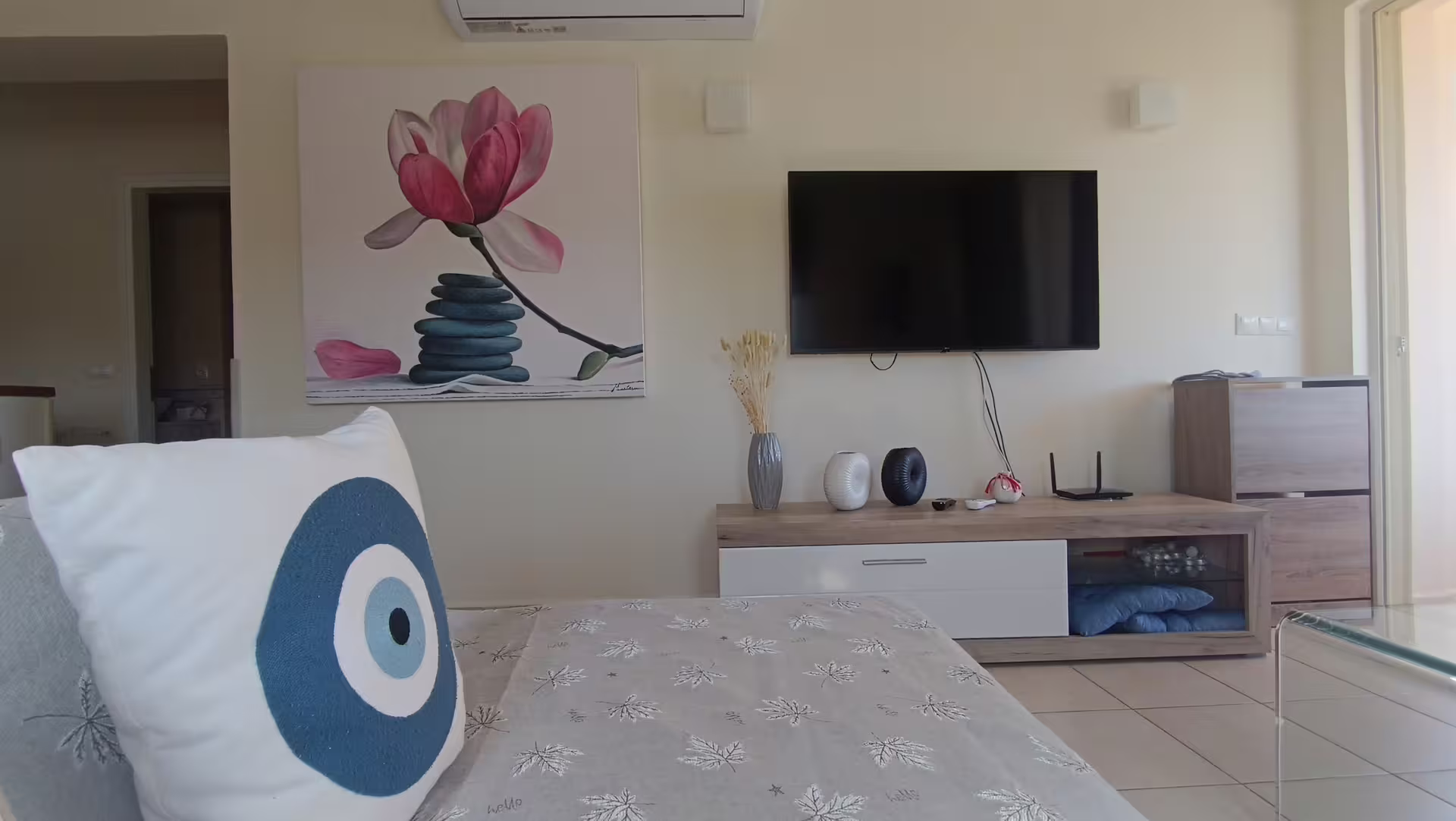 Modern living room with stylish decor, flat-screen TV, and comfortable seating at Infinity Night Villa for 8 guests.