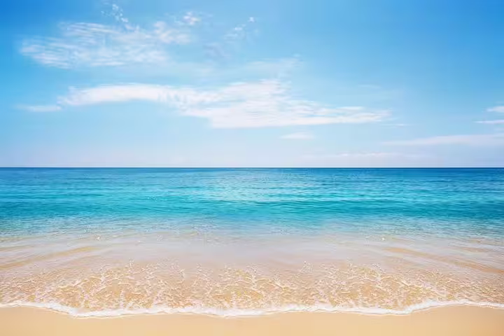 Pristine beach with turquoise waters perfect for a quick swim during the inland sea safari experience.