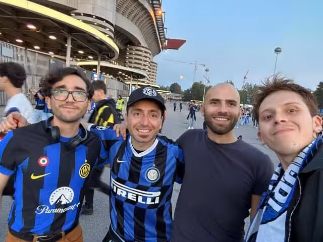 Inter fans selfie outside San Siro, Milan, meeting locals for a football match day experience and pregame vibes