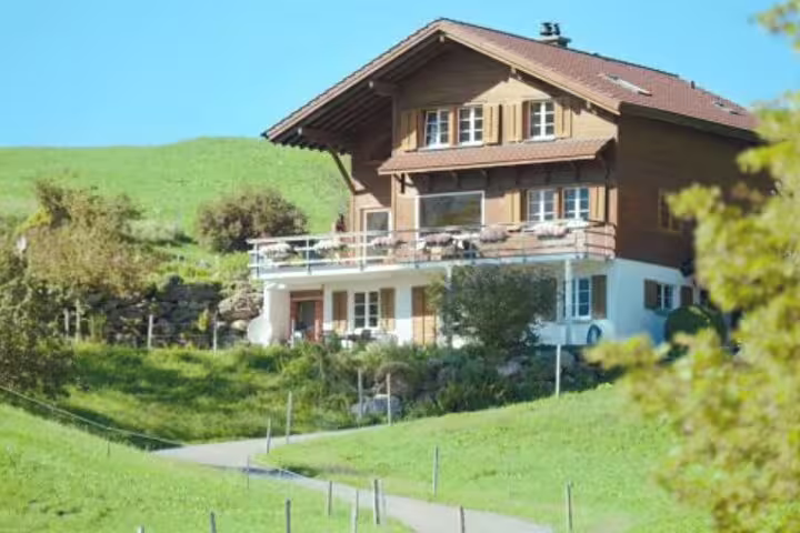 Charming Swiss chalet in lush green Interlaken, a key filming location for the Crash Landing on You tour.