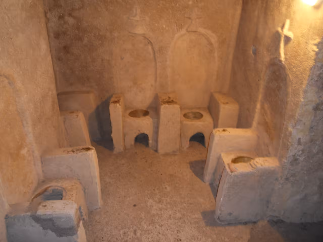 Ancient stone latrine room inside Ischia Aragonese Castle on an English guided history tour