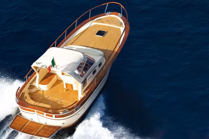 Luxurious yacht cruising through the azure waters of Ischia, perfect for a scenic tour of the Italian islands.