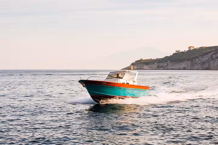 Speedboat cruising through the serene waters of Ischia and Procida, offering an idyllic small-group tour experience.