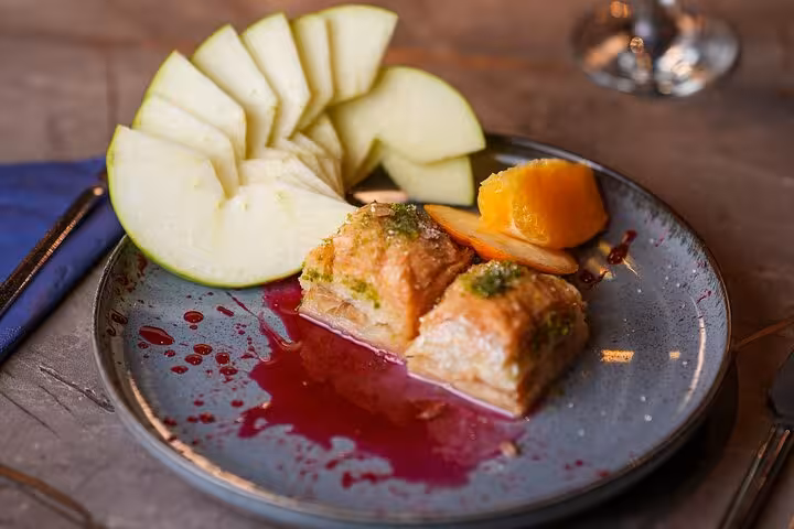 Turkish baklava dessert with fresh melon served during Istanbul Bosphorus dinner cruise Turkish night show