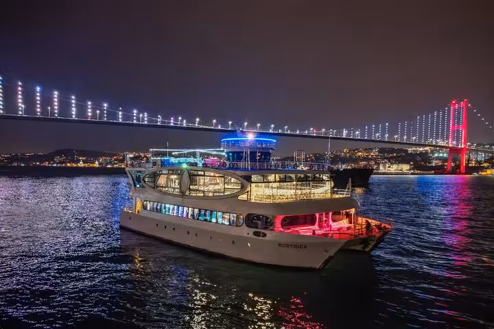 Istanbul Bosphorus dinner cruise yacht at night near Bosphorus Bridge, private table and city lights