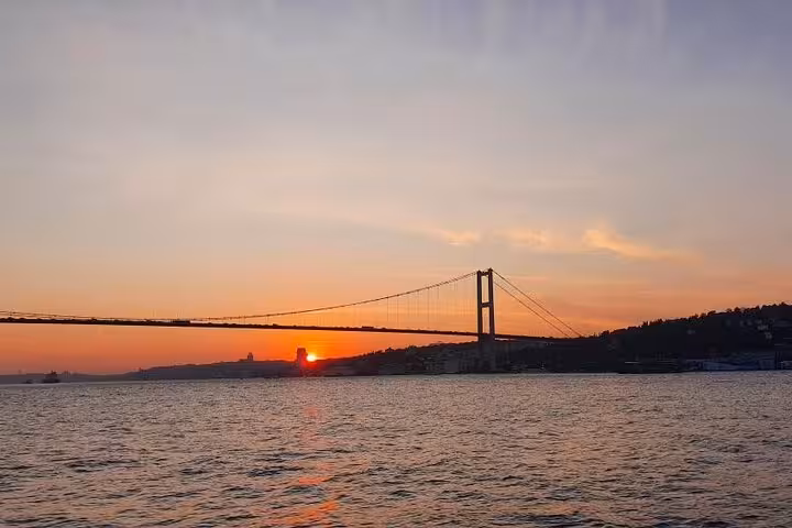 Golden Horn and Bosphorus sunset cruise view of Istanbul’s Bosphorus Bridge over calm waters