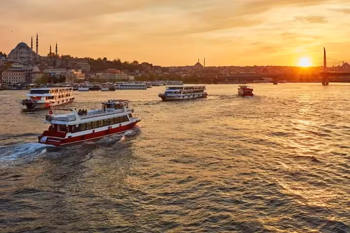 Golden-hour view of Istanbul waterfront from Bosphorus sunset yacht cruise with boats and skyline