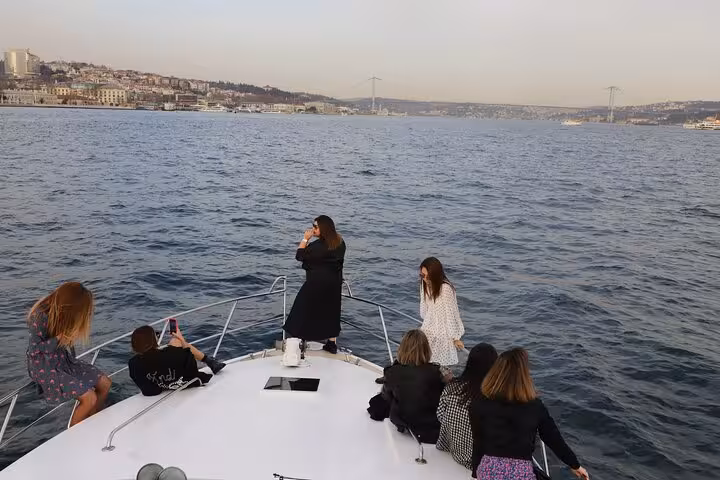 Friends enjoying the bow view on a luxurious yacht Bosphorus sunset cruise in Istanbul with skyline scenery