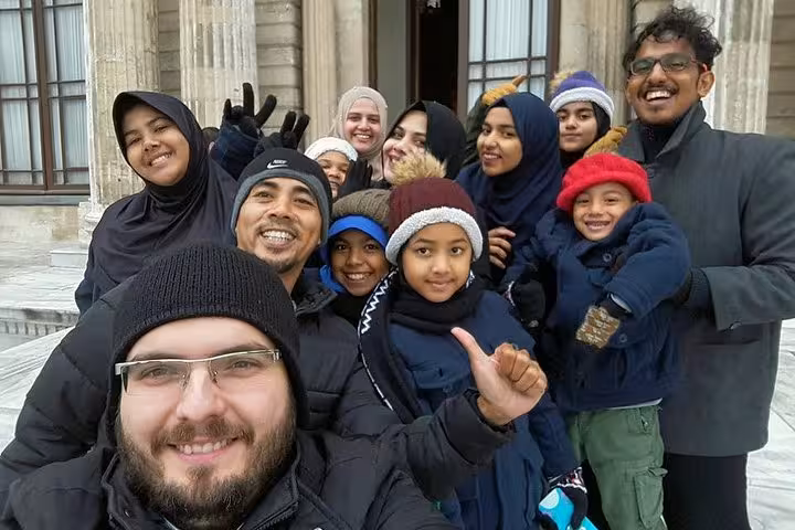 Happy tour group selfie at Topkapi Palace courtyard on Asia-Europe Istanbul tour with museum entry and lunch