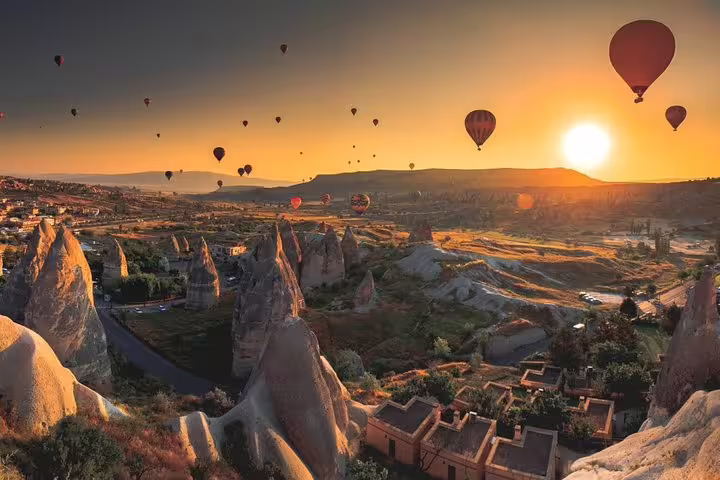 Sunrise hot air balloons over Cappadocia fairy chimneys on Istanbul to Cappadocia 3 days cave hotel tour