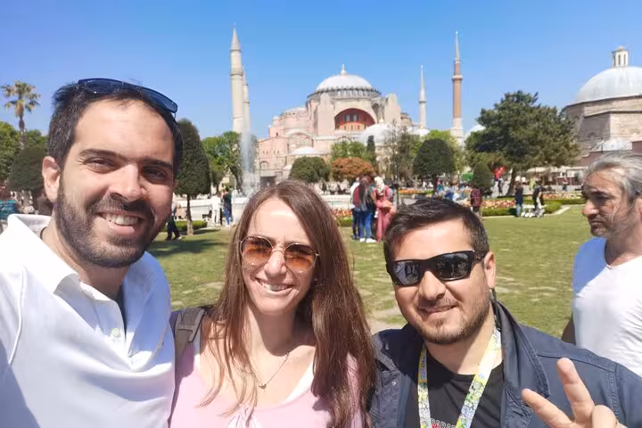 Guests with local guide in Sultanahmet Park, Hagia Sophia behind, Istanbul stop on 3 days private tour Turkey