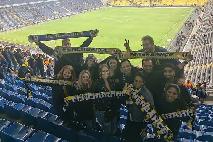 Group of travelers with Fenerbahçe scarves at Şükrü Saracoğlu Stadium, Istanbul local football experience