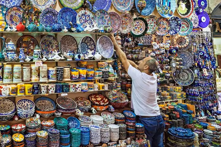 Grand Bazaar ceramics stall in Istanbul with colorful Iznik plates, on a private guided city tour shopping stop