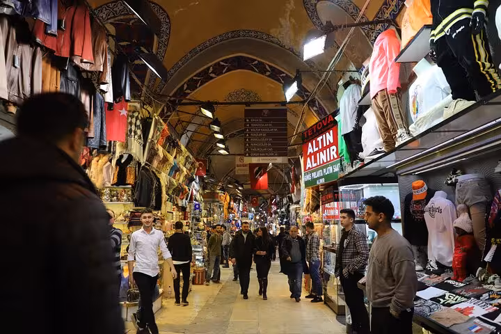 Bustling corridor inside Istanbul Grand Bazaar on Half Day Old City morning tour, shoppers and textile stalls