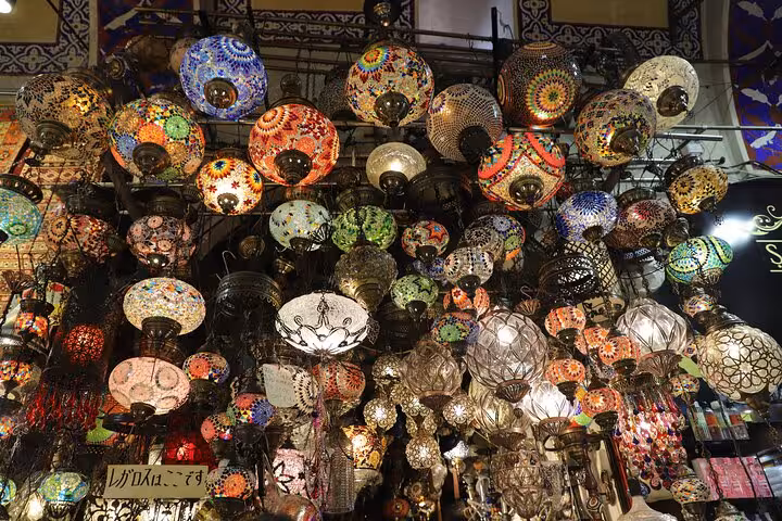 Colorful Turkish mosaic lamps hanging in Istanbul Grand Bazaar on Old City full-day tour with lunch