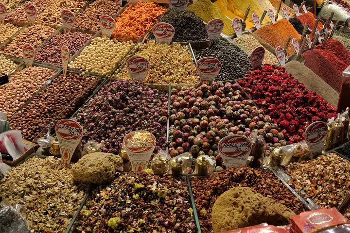 Vibrant display of spices and teas at Istanbul's Grand Bazaar, showcasing a rich variety of colors and textures.