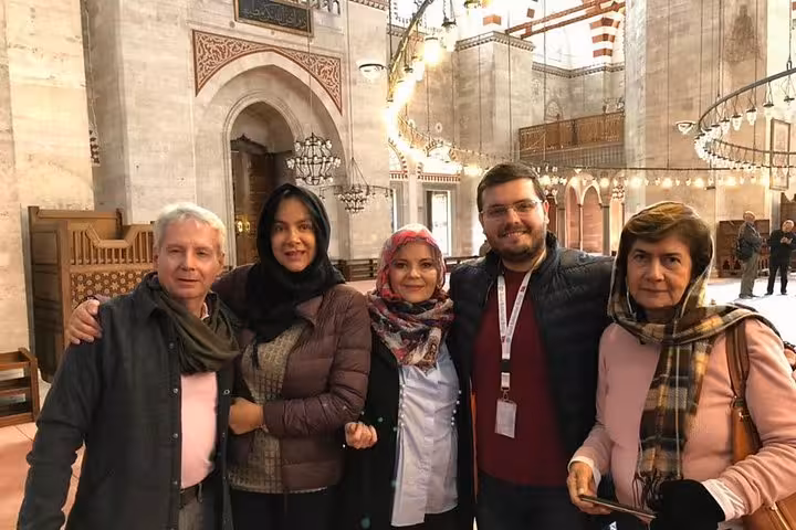Visitors inside an Istanbul historic mosque on Asia-Europe Bosphorus full day tour including museum entry and lunch