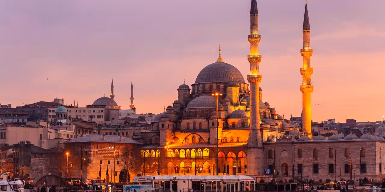 Istanbul mosque with domes and minarets at sunset
