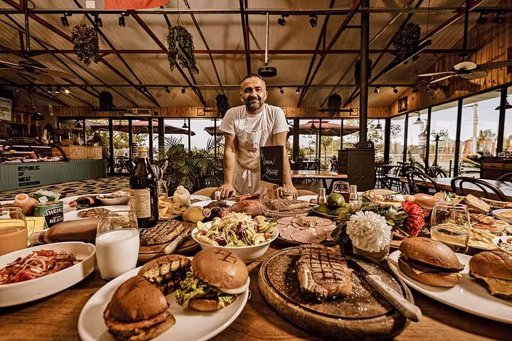 Private car tour with driver to local restaurant for gourmet lunch, grilled steaks, burgers and salads