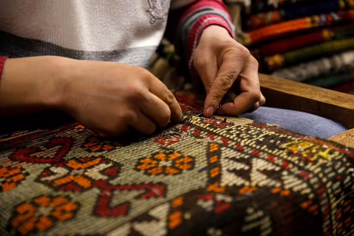 Experience traditional Turkish craftsmanship with a detailed view of handmade carpet weaving on the Istanbul private tour.