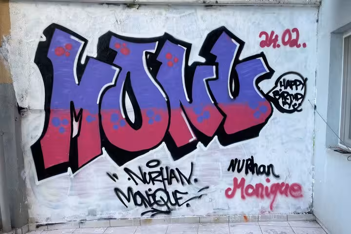 Bold “MONO” graffiti mural in Istanbul home garden during street art experience with local artists