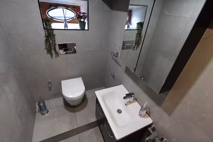 Modern bathroom on private Istanbul Bosphorus yacht cruise with sink, mirror and toilet for onboard comfort