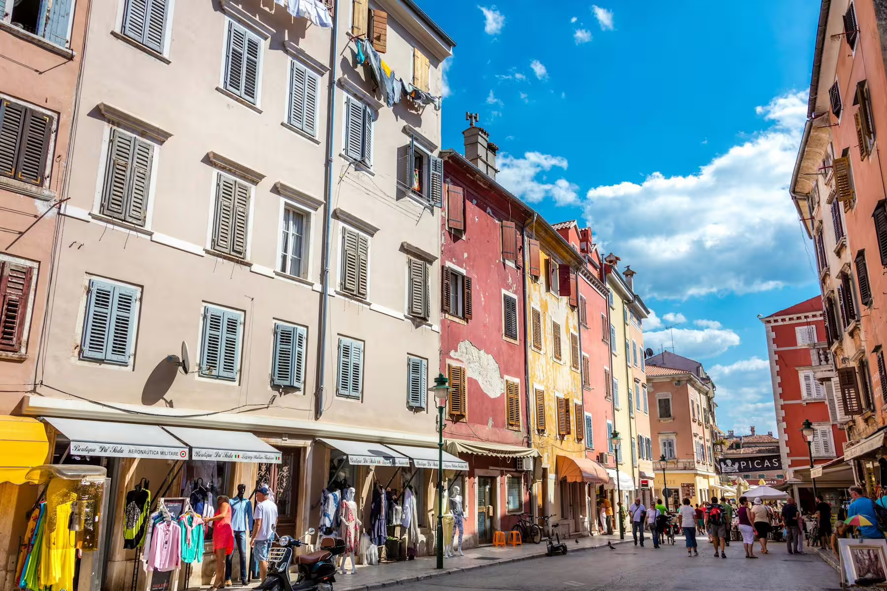 Colorful Istrian old town street stop on Poreč boat cruise with BBQ, shops and pastel facades