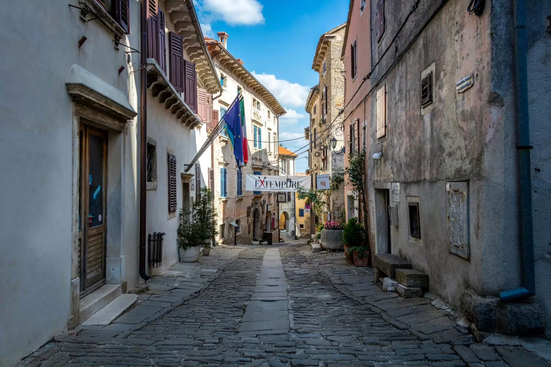 Cobbled lane in an Istrian hilltop village old town, perfect stop on a local tasting tour in Croatia