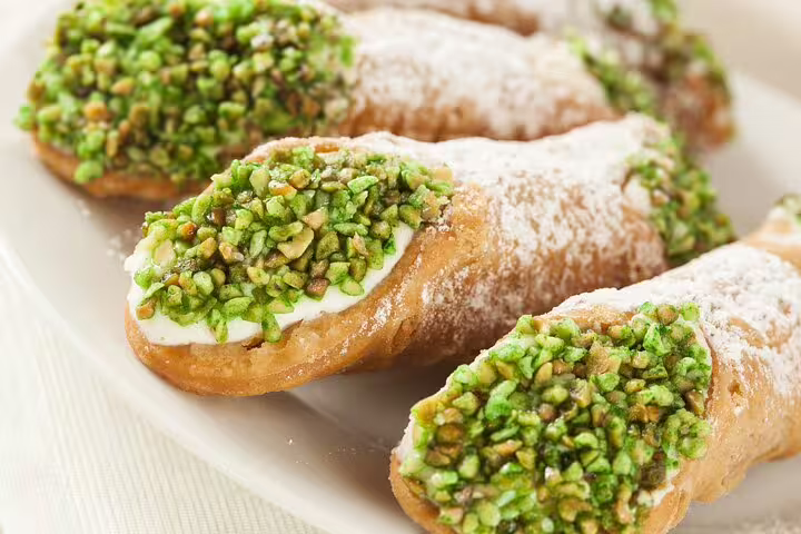 Delicious Italian cannoli topped with pistachios, perfect for savoring on an Aperitivo Foodie Tour with stunning Vatican views.