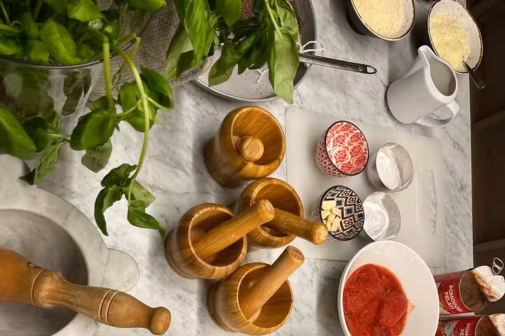 Fresh basil, tomatoes, and traditional tools ready for an authentic Italian cooking class experience.