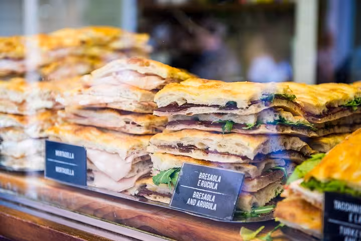 Delicious Italian focaccia sandwiches stacked in a display, perfect for a Rome Vatican walking food tour.