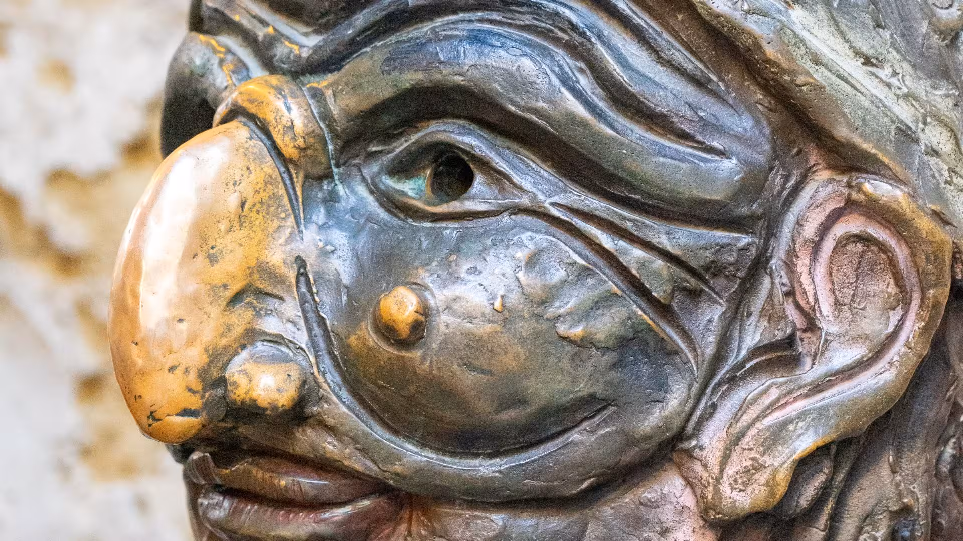 Close-up of a traditional Italian mask sculpture in Naples, part of the folklore tour experience.