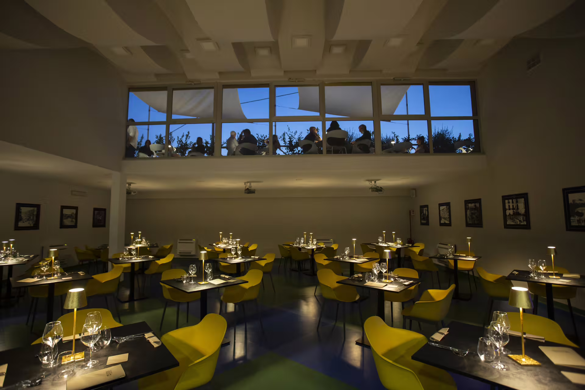 Elegant dining room at Italian pastificio tour, with candlelit tables and terrace view for gourmet pasta tasting experience