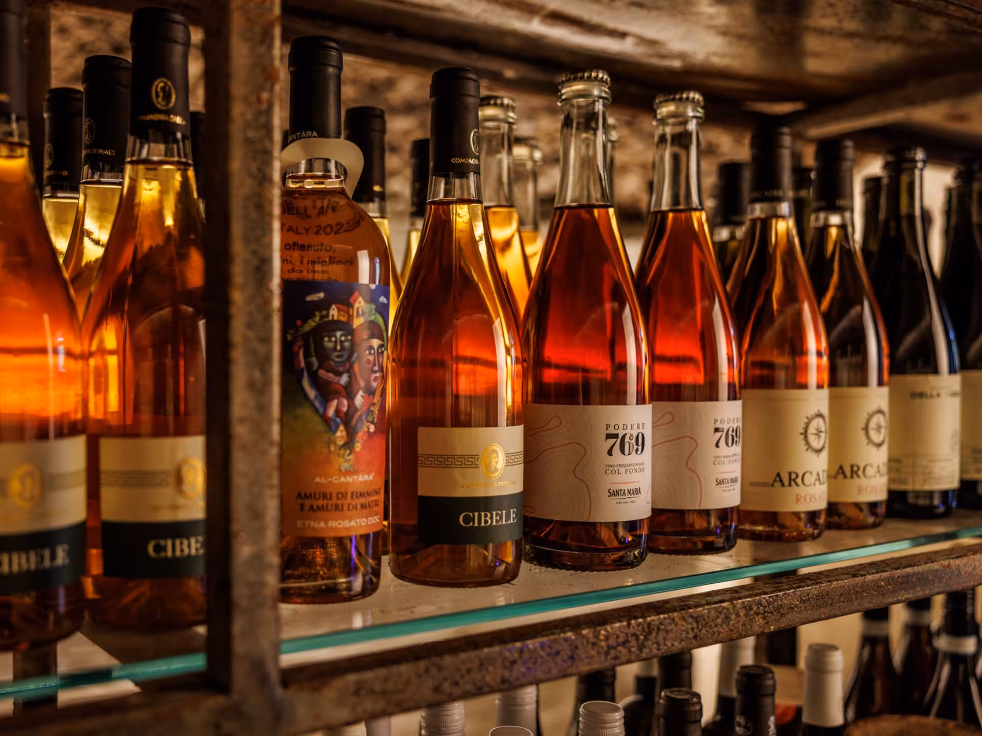 Selection of Italian wine bottles on display in an underground cellar in Rome, perfect for tasting and pairing tours.
