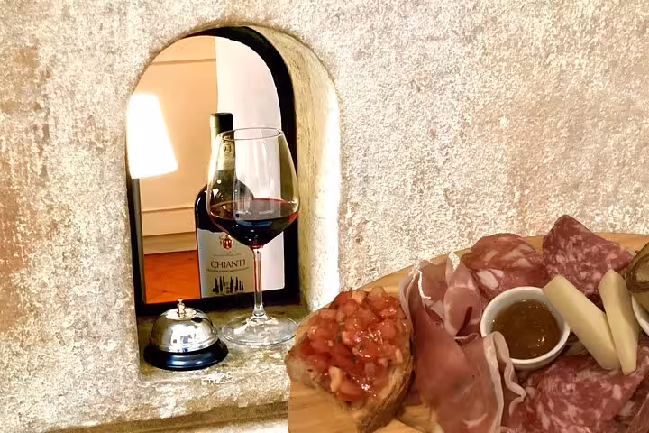 Enjoy authentic Italian wine and appetizers at a historic wine window during the Wine Windows Walk tour.