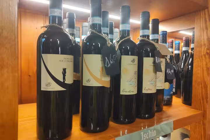 A selection of Italian wines displayed on a wooden shelf, highlighting diverse labels for wine education.