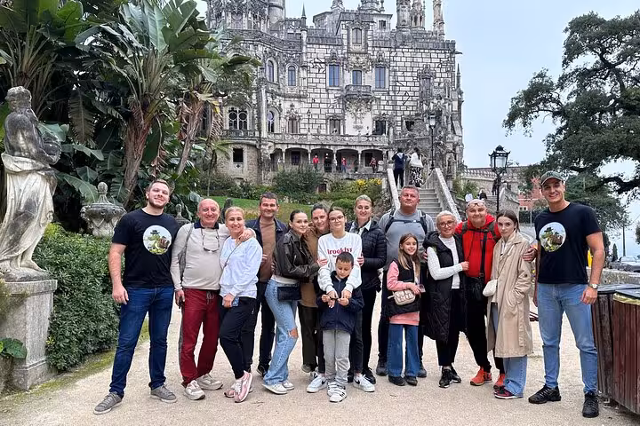 Group of tourists in front of an ornate Sintra palace, capturing the essence of the 007 private tour of Portugal's coast.