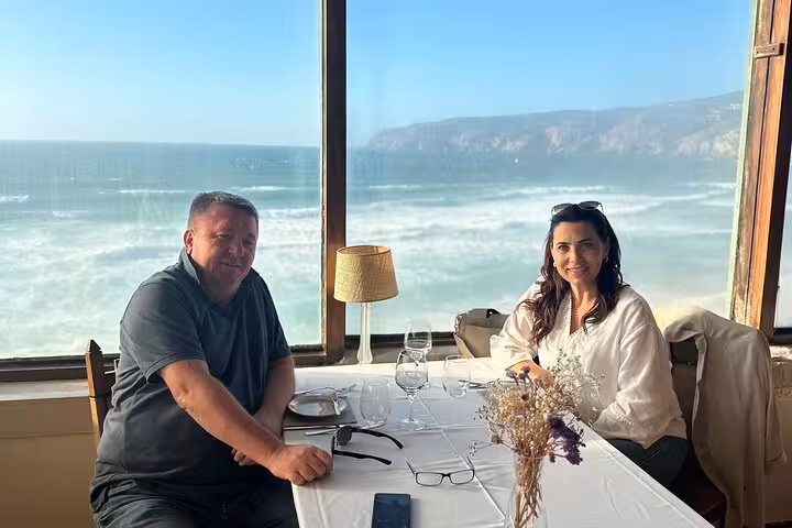 Couple enjoying a meal with stunning Atlantic Ocean views on the Sintra and Atlantic Coast private tour.
