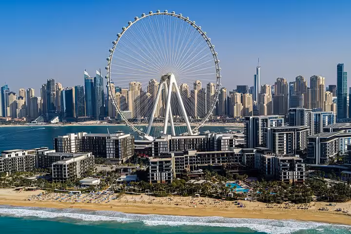 Aerial view of JBR Beach with Ain Dubai Ferris wheel and Dubai Marina skyline, highlighting a top Instagrammable spot.
