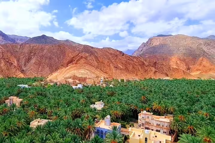 Discover the lush palm oasis and rugged mountains on the Private Overnight Jebel Shams Camping Tour for a scenic adventure.