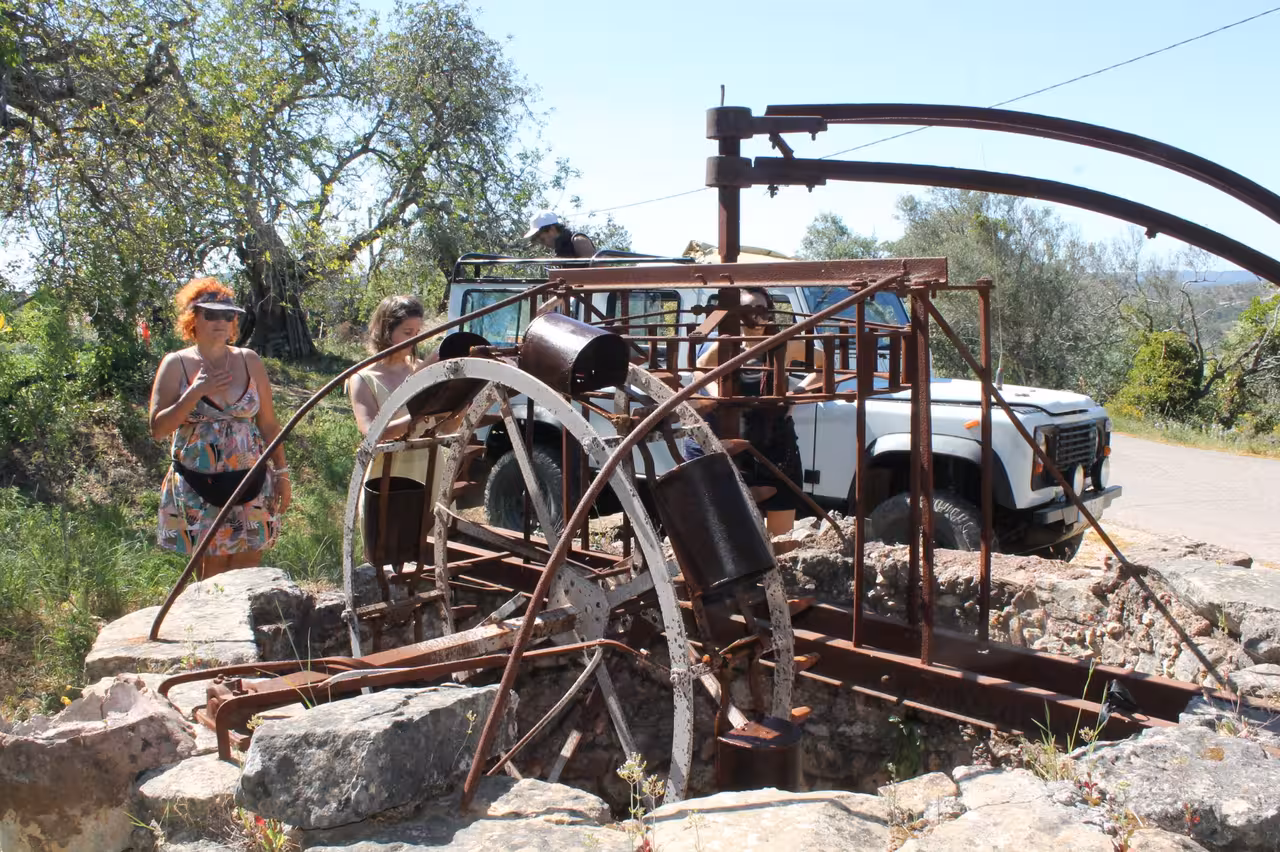 Jeep safari stop at a rustic waterwheel in Algarve countryside on the Benagil cliffs coast tour